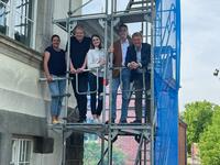 Bild vergrößern: Auf dem Baugerüst stehen fünf Personen. Von links: Frau Kappis, Herr Marks, Frau Graf, Herr Glienke und Bürgermeister Dr. Brinkmann